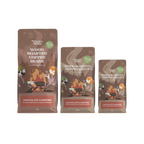 Three bags of Wholey Moley Wood Roasted Coffee Beans in different sizes, featuring a brown and orange campfire illustration on a white background.